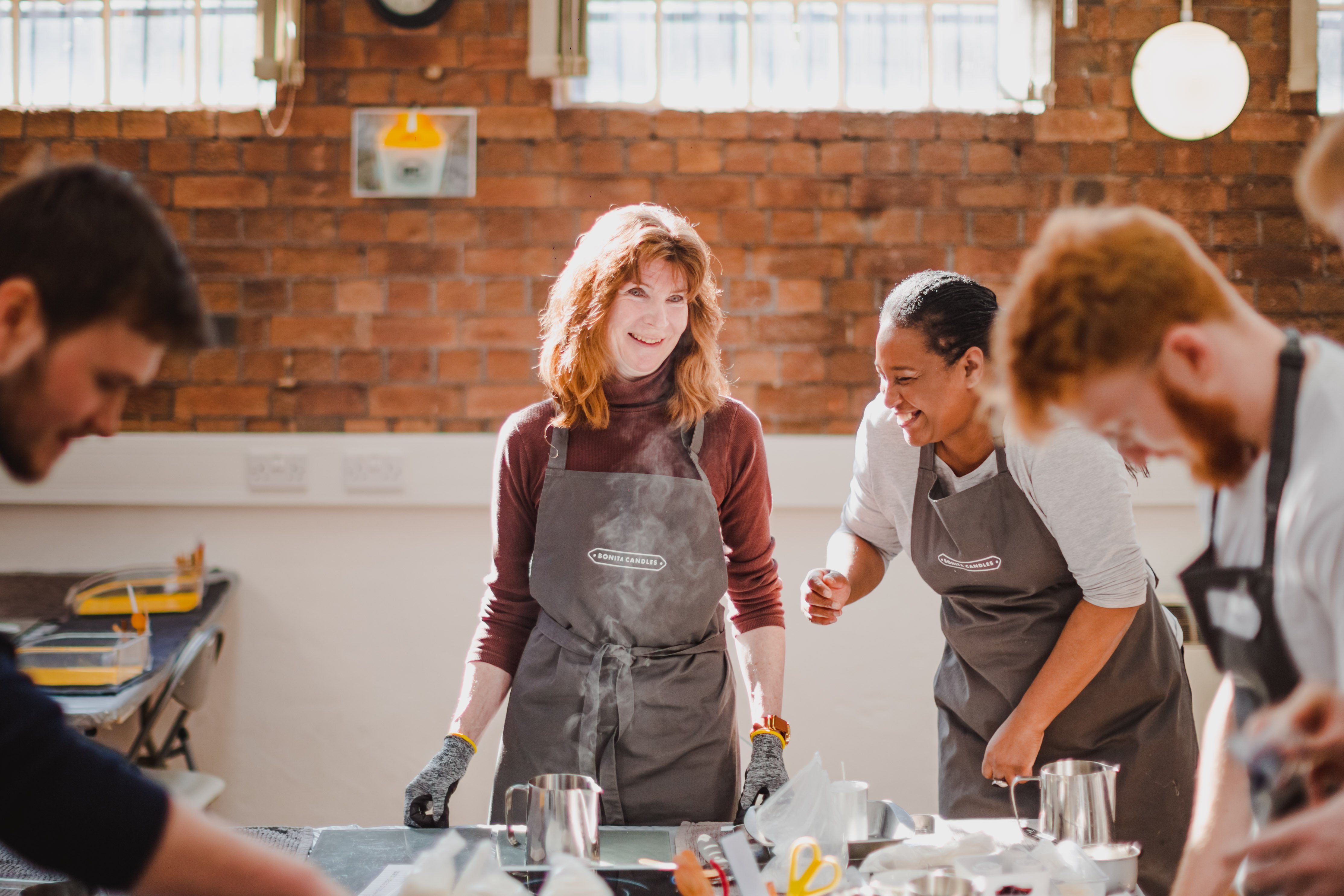 A teacher and her students at a candle making class